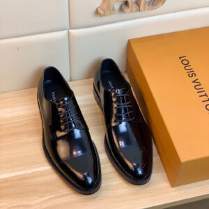 A pair of Louis Vuitton Black Leather Derby Shoes with high-shine finish and brogue toe detail.