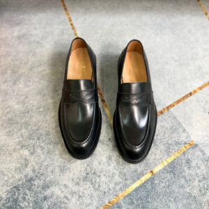 Front view of Louis Vuitton Black Major Loafers with Monogram canvas trim and flower-embossed heels.