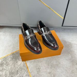A pair of Louis Vuitton Black Woven Loafers featuring silver hardware and monogram detailing on a grey background.