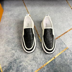 Top view of Louis Vuitton Black and White Monogram Loafers showing the embossed leather and white sole.