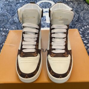A pair of Louis Vuitton Boombox Sneaker Boots in white leather and brown monogram canvas, showing the high-top profile and adjustable logo ankle strap.