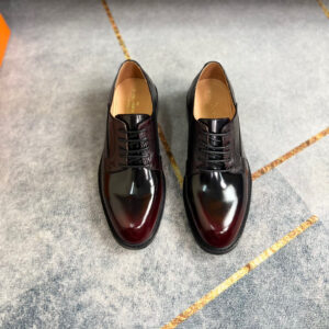 A pair of Louis Vuitton Burgundy Vendôme Derbies featuring a gradient leather patina and ribbed texture.