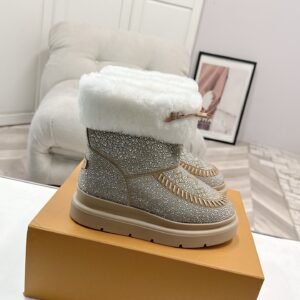A pair of Louis Vuitton Champagne Rhinestone Boots with shimmering crystals and white fur trim