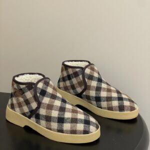 A pair of Louis Vuitton Checked Damier Shearling Boots in brown checked canvas with beige fur trim and a thick lug sole.