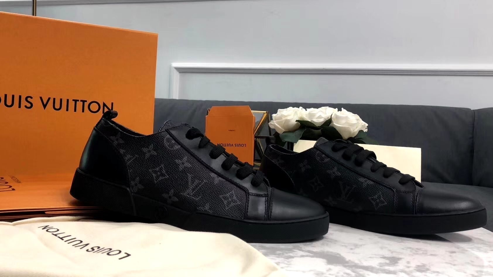 Rear and side view of the Louis Vuitton Match-Up Sneaker in black monogram showing the leather heel tabs and the LV signature canvas side panels.
