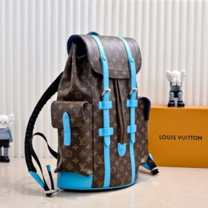 A front-view of the Louis Vuitton Monogram Canvas Christopher PM Backpack with brown Monogram canvas and bright blue leather trim and straps.