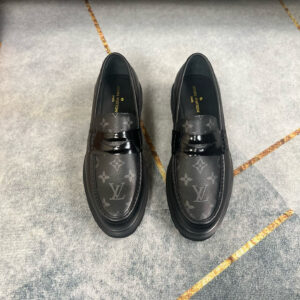 Black Louis Vuitton loafer featuring Monogram Eclipse canvas on the toe, a patent leather strap, and a chunky lug sole with floral details.