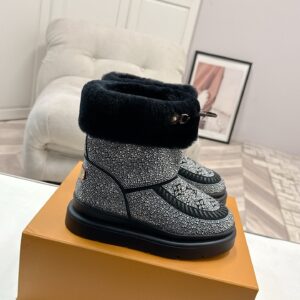 A pair of Louis Vuitton Silver Rhinestone Boots shimmering with crystals and featuring a black fur collar and platform sole.