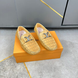 Louis Vuitton Tan Croc Texture Classic Loafers shown with tan crocodile style texture, slip on design, metallic emblem detail, and flat sole