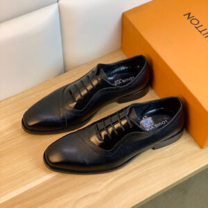 Louis Vuitton Textured Panel Black Oxford shoes featuring a mix of textured and smooth leather on an orange display box.