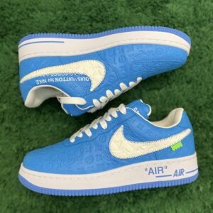 Side and rear view of Louis Vuitton x Nike Air Force 1 Low sneakers in blue and white with monogram embossing on a green textured surface.
