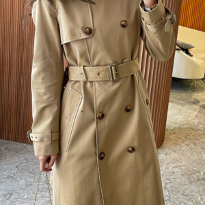 Mid-length beige double-breasted trench coat for women with an abstract logo-style patterned collar, tonal buttons, and a fabric belt.