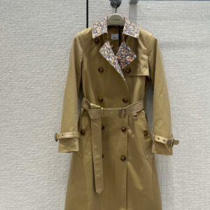 Mid-length double-breasted unisex trench coat in Honey beige with a contrast orange monogram check collar and belted waist.