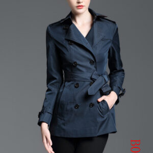 Cropped navy blue double-breasted trench coat for women with a self-tie fabric belt, dark buttons, and sharp collar details, styled on a model.