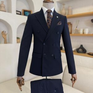 A men's Navy Blue Double Breasted Peak Lapel Suit featuring a patterned tie and pocket square on a display mannequin.