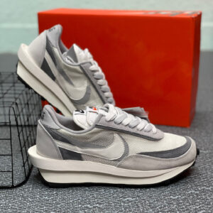 Side view of the Nike Grey White Waffle Shoe with grey suede overlays and a chunky stacked white midsole.