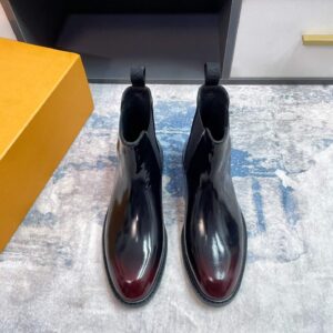 Pair of Patent Finish Patina Chelsea Boots in high-gloss black leather with red/burgundy toe patina.