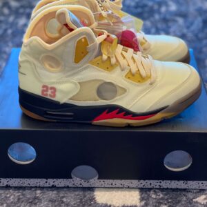 Close-up side profile of the Jordan 5 Retro Off-White Sail showing the "23" branding and circular window.