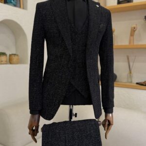 A men's Sparkling Black Galaxy Slim Fit Suit featuring a shimmering texture, matching vest, and black tie on a mannequin.