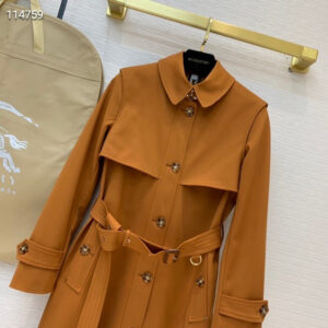 Long double-breasted trench coat in Iridescent Mahogany/Plum with belted waist and check lining. Westminster-style design.