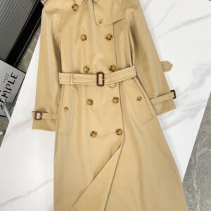 Long double-breasted unisex trench coat in Light Beige/Honey with a belted waist and classic check lining. Westminster-style coat.