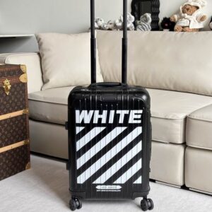 Front view of the Chanel Black Stripe Suitcase in matte black with white diagonal stripes and the "WHITE" logo.