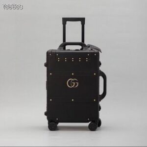 Top view of a Gucci Black Rolling Suitcase with gold studs and a telescopic handle.
