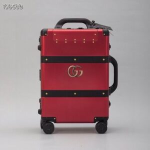 Front view of a Gucci Red Rolling Suitcase with black trim and the gold interlocking GG logo.