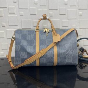 A large Louis Vuitton Blue Damier Keepall Travel Bag in blue checkered canvas with tan leather straps and a gold padlock.
