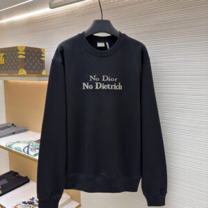 A premium Dior Black Slogan Sweatshirt featuring silver-grey embroidery hanging in a luxury closet setting.
