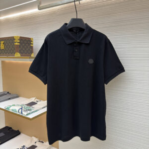 A sleek Moncler Black Textured Polo with a tonal chest logo hanging in a modern luxury store.