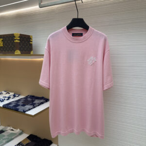A premium Louis Vuitton Men’s White Paris Spray T-Shirt in white, hanging on a black hanger, displaying the black spray-paint effect logo on the chest.