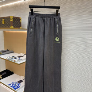 Front view of Acne Studios Charcoal Grey Sweatpants featuring wide legs and lime green logo embroidery on a display hanger.