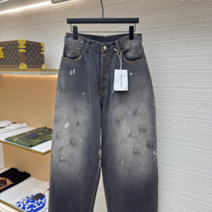 Front view of Acne Studios Dark Grey Baggy Jeans featuring a voluminous leg and stone-wash finish on a display hanger.