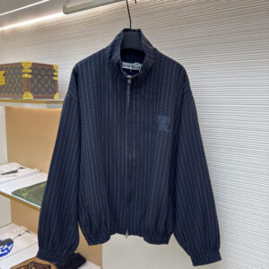 Acne Studios Navy Pinstripe Jacket in navy blue featuring white pinstripes and an embroidered bow logo on the chest.