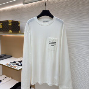 Front view of the Acne Studios White Long Sleeve T-Shirt showing the chest pocket and Stockholm 1996 graphic on a display hanger.