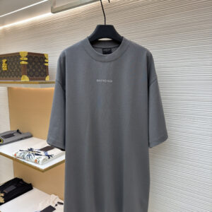 A high-quality Balenciaga Gray "Shadow Logo" Oversized T-Shirt in charcoal gray. The image shows the bold tonal brand name printed across the back shoulders.