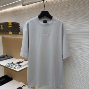 A high-quality Balenciaga Light Gray Pink Logo Oversized T-Shirt in mist gray. The image shows the bold pink brand name printed across the back shoulders in a shadow style.