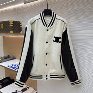 A cream and black Celine Paris varsity jacket with bold back lettering hanging in a luxury closet.