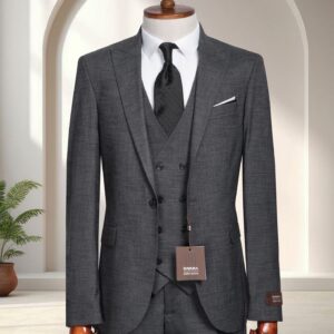 A man’s dark grey textured three-piece slim-fit suit with a double-breasted waistcoat and black silk tie on a mannequin.