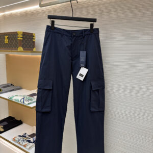 A pair of Dior Navy Cargo Trousers hanging on a black hanger, showing the front and back views including the cargo pockets and logo details.