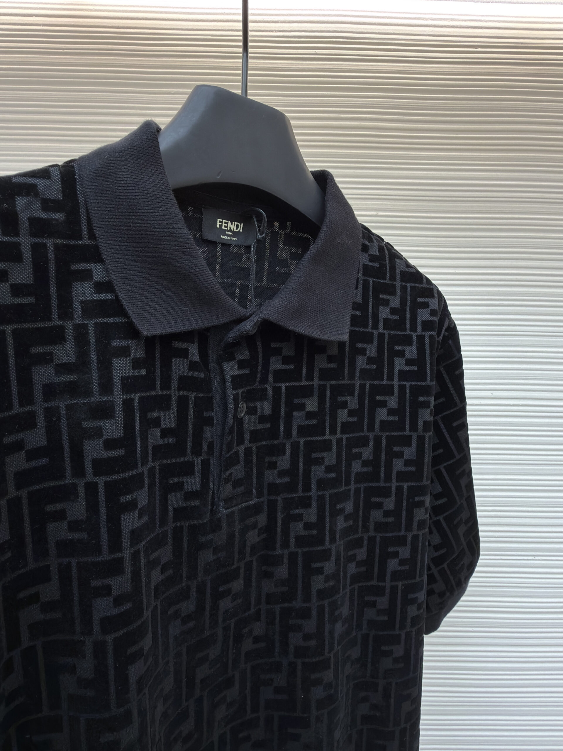 A premium Fendi Men’s Black FF Monogram Velvet Polo Shirt in black, showing the intricate all-over velvet FF monogram pattern.