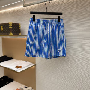 A pair of Louis Vuitton Blue Striped Shorts featuring azure blue and white vertical stripes and a signature LV patch on the hem