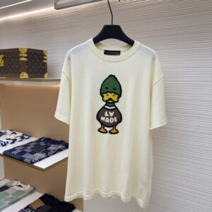 A premium Louis Vuitton Cream Duck Intarsia T-Shirt in cream, hanging on a black hanger, showing the front view with a colorful duck graphic and a clean back view.