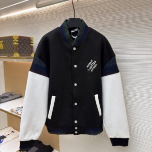 A high-contrast black and white Louis Vuitton varsity jacket with iridescent ribbing and white script embroidery on the chest.