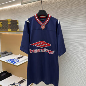 Front and back view of a premium navy blue oversized athletic jersey with red and white embroidery hanging in a luxury boutique.