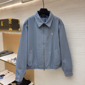 Front and back view of a blue Ralph Lauren cotton zip-up jacket hanging in a luxury retail setting.