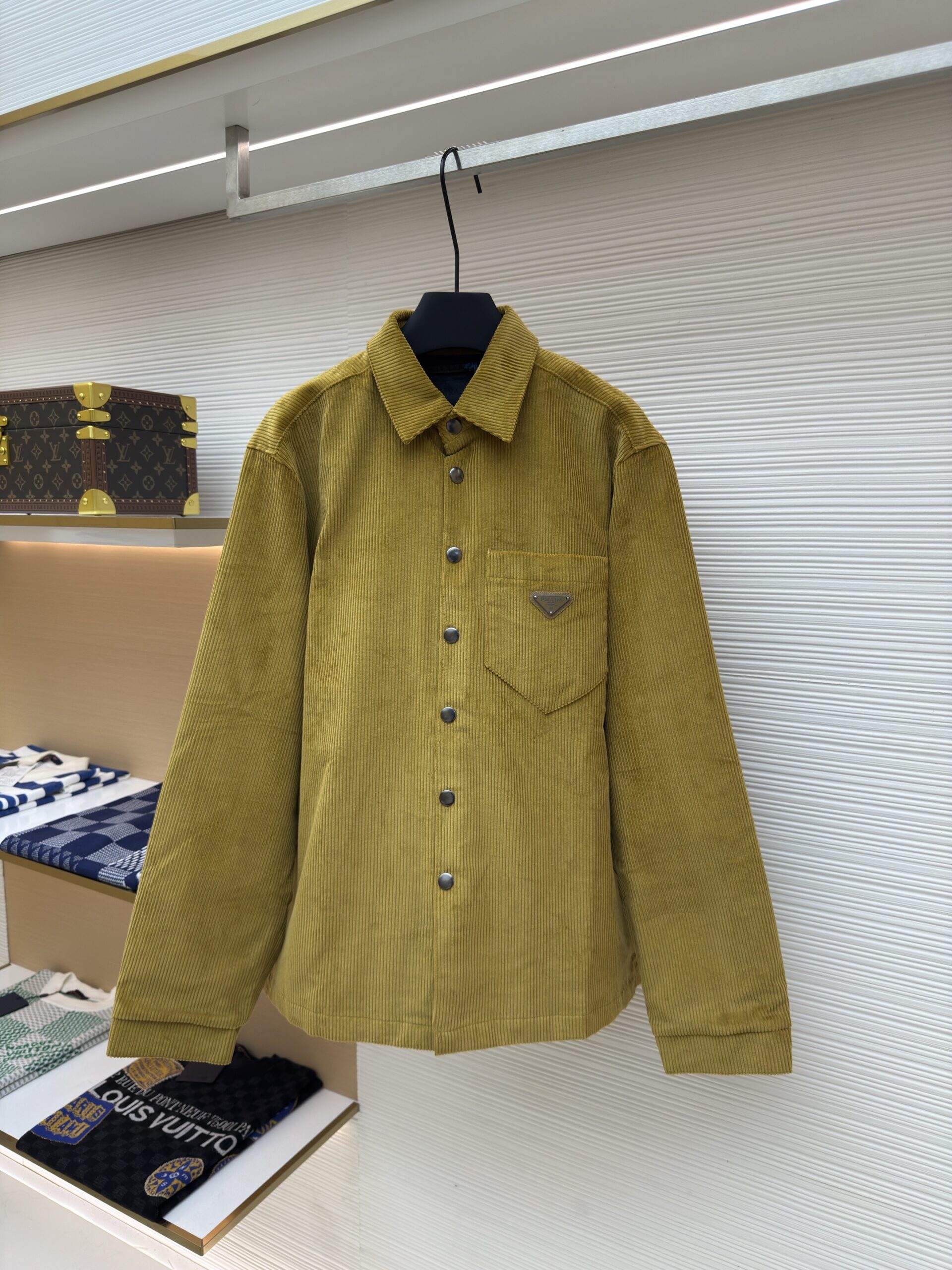 Mustard yellow Prada corduroy overshirt with long sleeves, chest pocket featuring the enamel triangle logo, and metallic snap buttons.