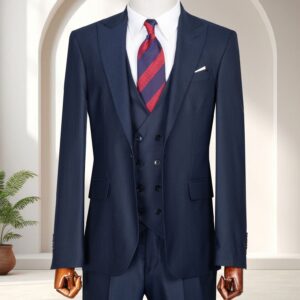A Premium Beige Three-Piece Suit featuring a double-breasted waistcoat and tonal striped tie on a wooden mannequin.