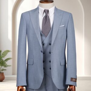 A man’s sky blue textured three-piece slim-fit suit with a double-breasted waistcoat and grey patterned tie on a mannequin.